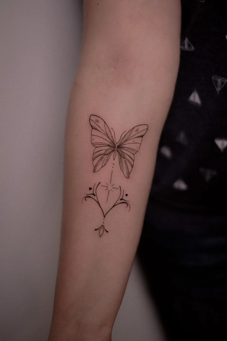 Fine-line butterfly with ornamental heart