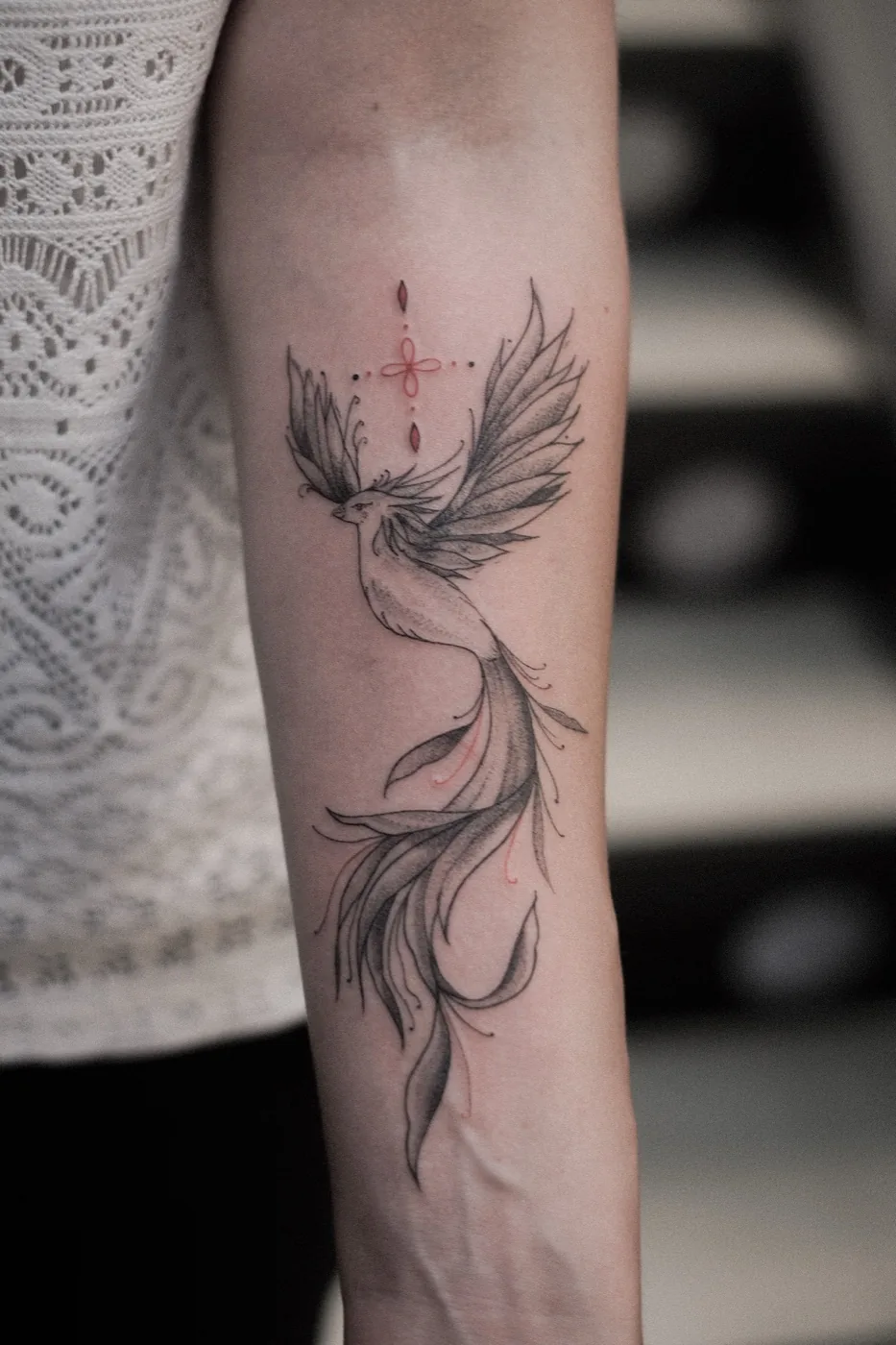 Phoenix with red accents on forearm