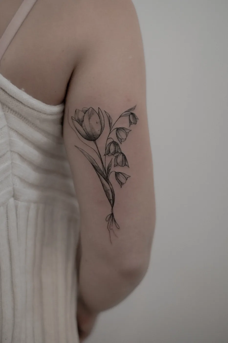 Tulip and bluebell bouquet on arm